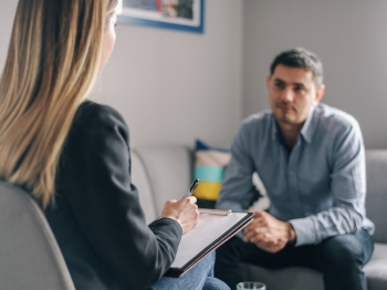 Man speaking to woman