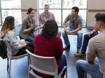 Group of people sitting together in circle