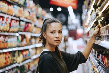 Woman in store choosing grocery items