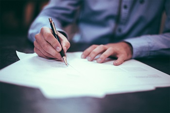 Man writing at desk