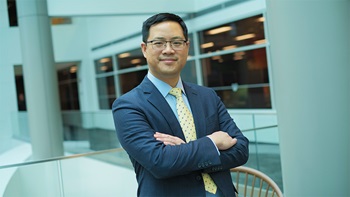 Man in business suit smiling with crossed arms