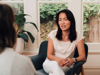 Women in room speaking with someone